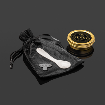 imperia spoon next to a tin of caviar 